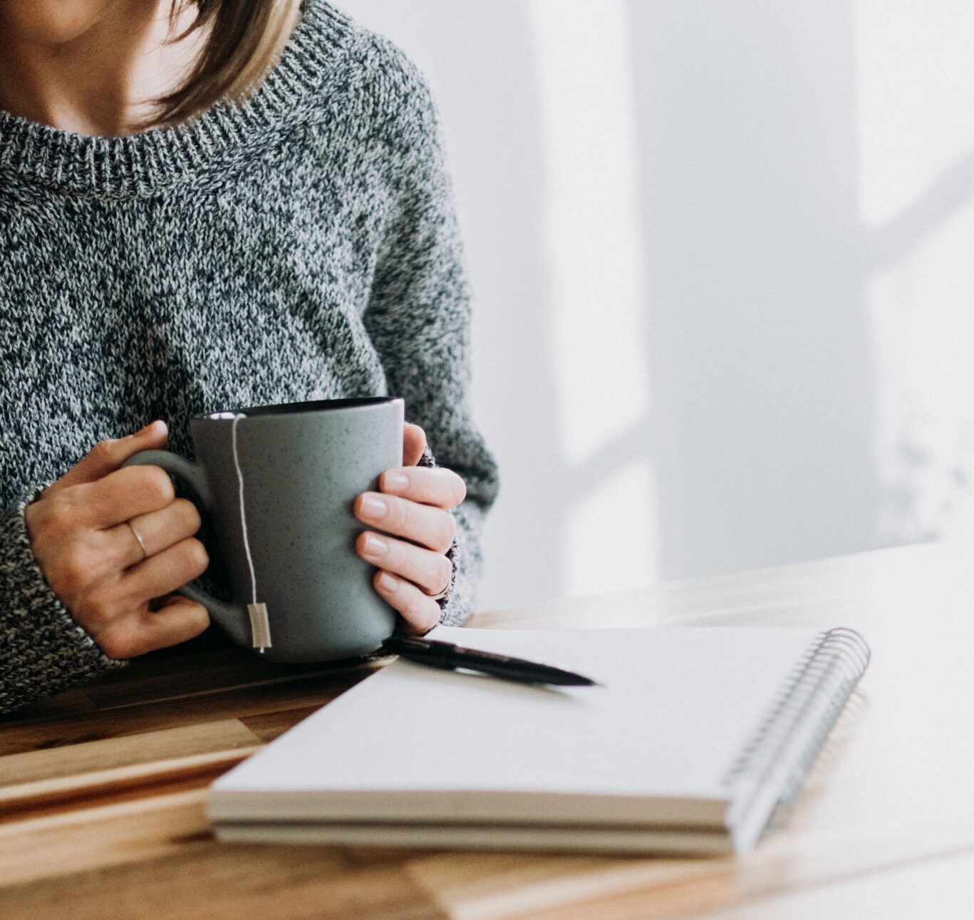 FAQ picture of a girl with a mug and paper